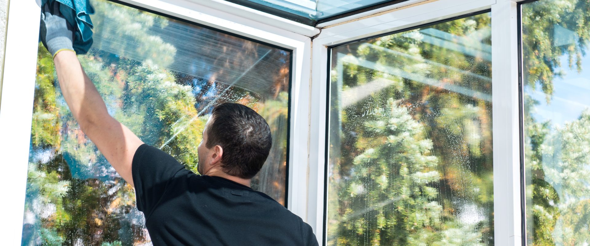 Man cleaning conservatory windows